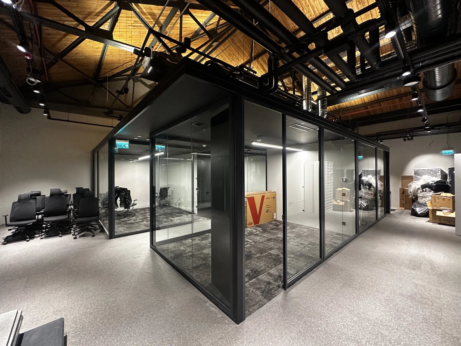 Exposed building services above the glazed office spaces at Bomontiada.